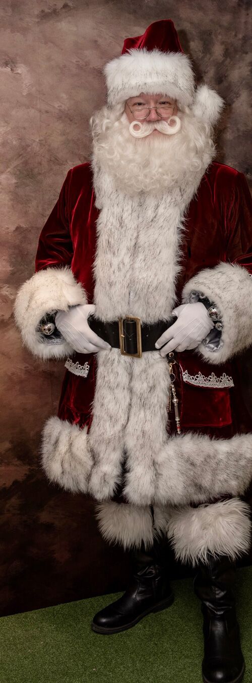 Full-length portrait of Santa Joe in his custom suit, black belt and boots